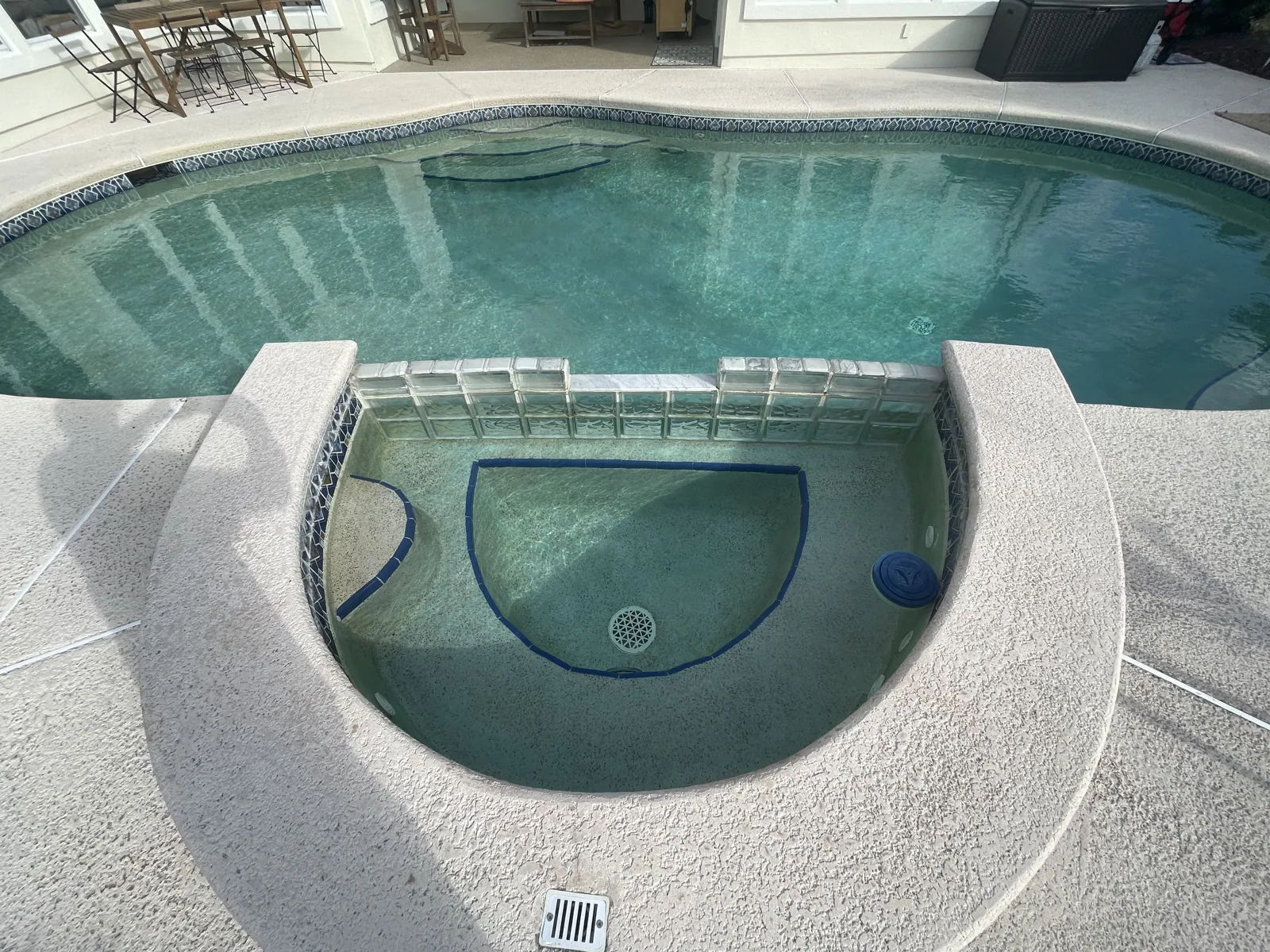 Raised spa with spillover into a custom freeform pool