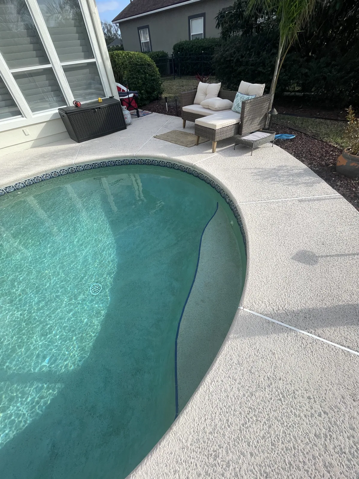 Custom pool with a raised spa inside a screened lanai