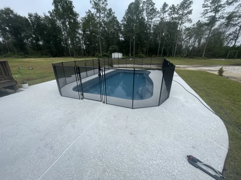 Rectangular fiberglass pool with roman-end steps and clear blue water