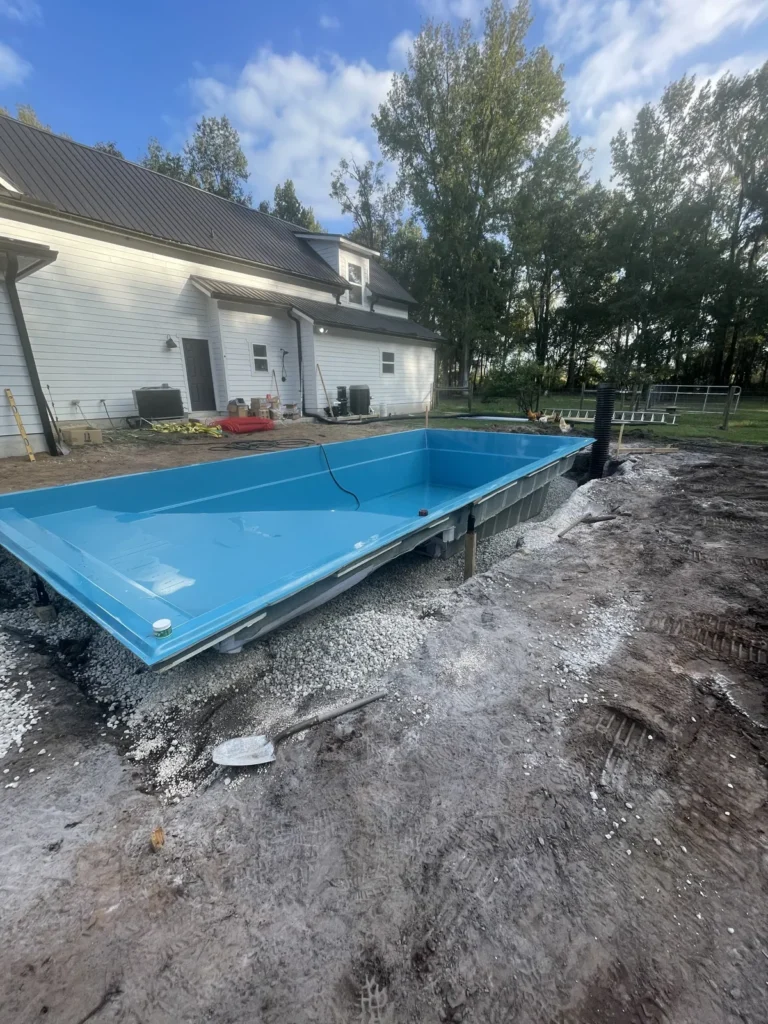 Fiberglass pool shell set on its compacted gravel base and leveled