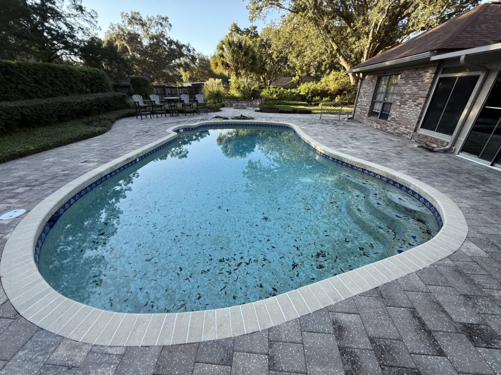 Neglected pool with algae-stained water, a candidate for a drain and clean