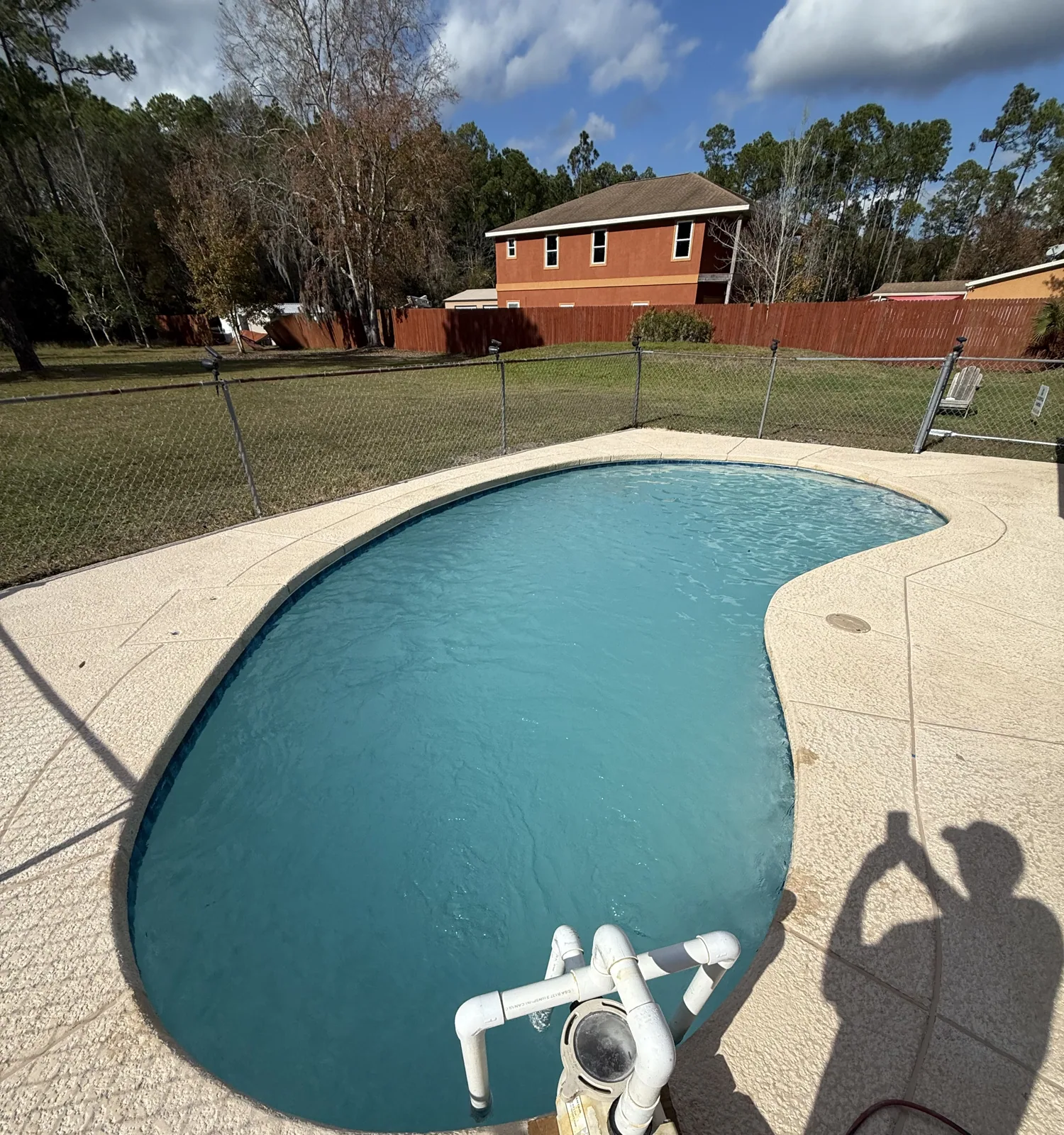 Finished pool remodel showing the new deck surface and waterline tile